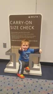 small child/toddler in carry on size check display