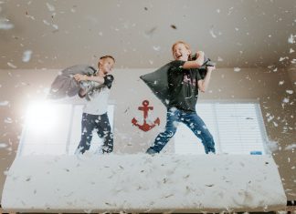 Two children having a pillow fight.